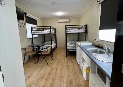 two bunk beds with a kitchenette